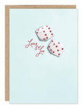 Biely & Shoaf "Lucky At Love" card—dice with red hearts, blue background, brown envelope. Perfect for anniversaries!.