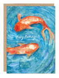 The Koi Fish Birthday Card by Biely & Shoaf features two orange koi swimming in swirling blue watercolor, with "Happy Birthday" in white cursive at the center.