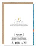 The back of the Koi Fish Birthday Card features text about artist Sarah Forster, her signature, and Biely & Shoaf Collection details. A gold sun-and-moon accent appears above her signature. Printed on FSC-certified recycled paper.
