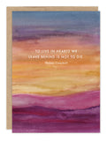 The Biely & Shoaf “To Live In Hearts” Sympathy Card features a watercolor sunset in purple, pink, orange, and blue with the quote: “TO LIVE IN HEARTS WE LEAVE BEHIND IS NOT TO DIE.” –Thomas Campbell.