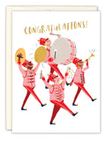 The Marching Band Congratulations Card by Biely & Shoaf features a joyful band in red uniforms playing instruments under the gold, handwritten CONGRATULATIONS!—a perfect greeting card illustrated by Sarah Long.