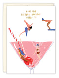 The Martini Make Your Hangover Worth It Birthday Card by Biely & Shoaf features three women diving into a pink cocktail and one swimming, with gold foil text—perfect for a playful birthday greeting on recycled paper.