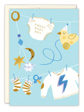 Charming illustration of baby boy items on a clothesline—onesie, sweater, socks, pacifier, mobile, toy bird, and cup—on a light blue background. Sweet Baby Boy New Baby Card by Biely & Shoaf. Illustrated by Sarah Long.
