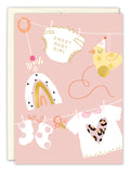 The Biely & Shoaf Sweet Baby Girl New Baby Card features a pink background with baby clothes, socks, a pacifier, rainbow, yellow pull-toy bird, and heart shirt. “SWEET BABY GIRL” in gold makes it a perfect congratulations card.