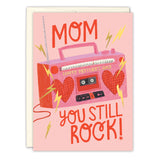 The Boom Box Mother's Day Card by Biely & Shoaf features Sarah Long's illustration of a red radio on a pink background with yellow lightning bolts, heart-shaped speakers, and "MOM, YOU STILL ROCK! HAPPY MOTHERS DAY" in bold red and yellow letters.