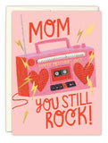 The Boom Box Mother's Day Card by Biely & Shoaf features a pink and red boombox with heart speakers, yellow lightning bolts, and bold red and yellow text: MOM HAPPY MOTHER'S DAY YOU STILL ROCK! Illustrated by Sarah Long.