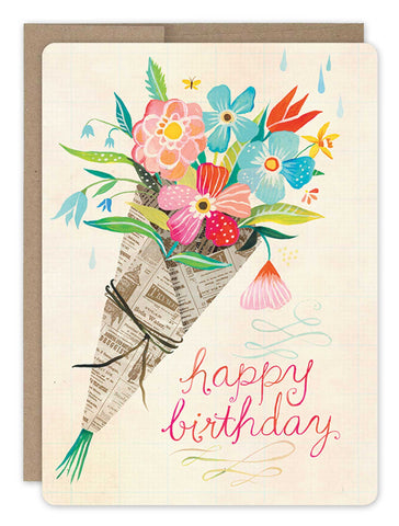 Introducing the Bouquet Birthday Card by Biely & Shoaf: A vibrant and colorful masterpiece adorned with a bouquet of lively flowers wrapped in newspaper. The card showcases "Happy Birthday" elegantly written in pink cursive lettering, surrounded by charming raindrops and a little bee spreading happiness.